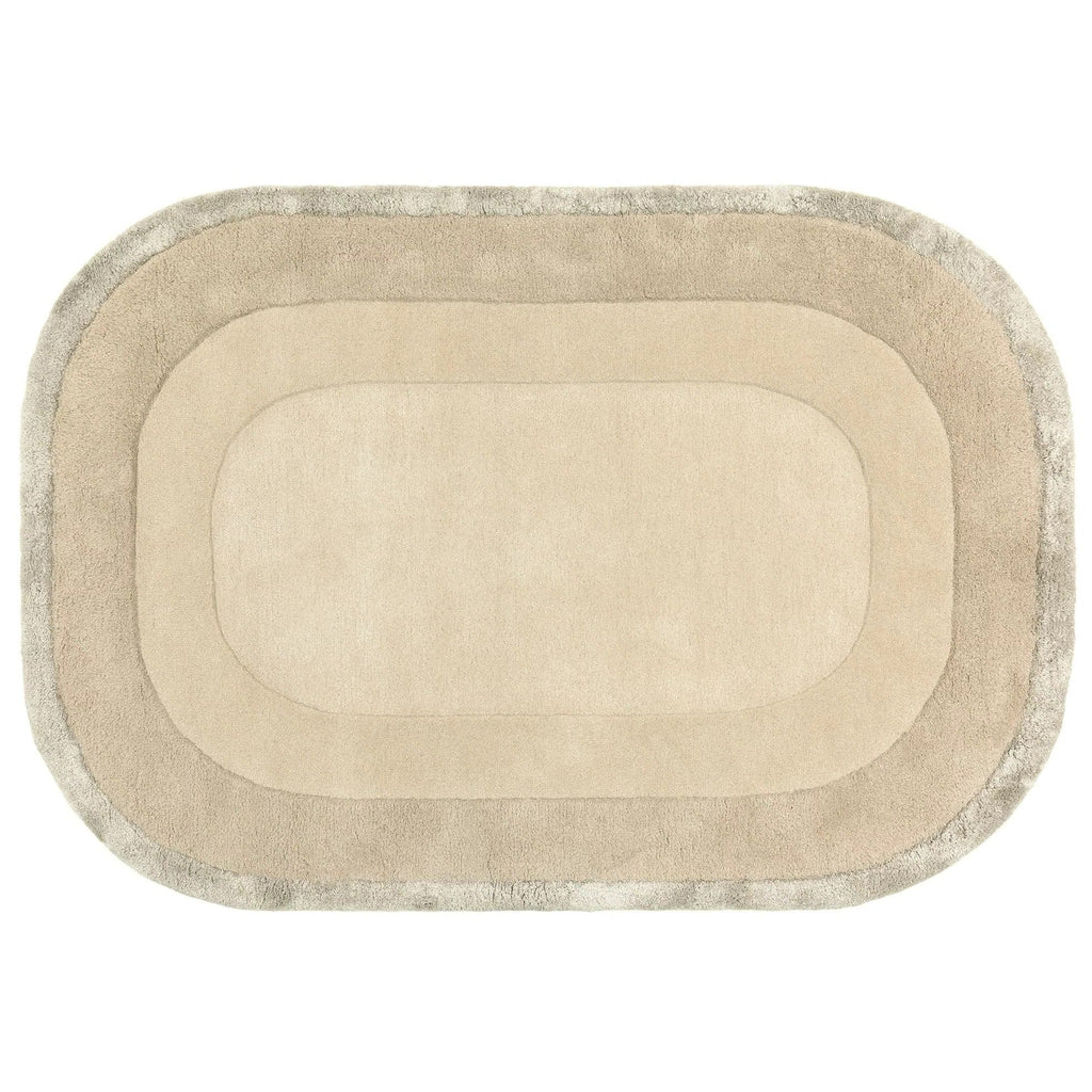 Beige oval rug with a textured border on a white background