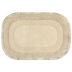 Beige oval rug with a textured border on a white background