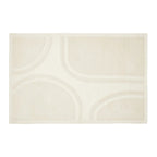 An off-white rectangular area rug with a subtle, tonal geometric pattern of curved lines and arches.